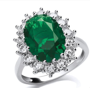 STERLING SILVER OVAL EMERALD AND CUBIC ZIRCONIA CLUSTER SOLITAIRE RING